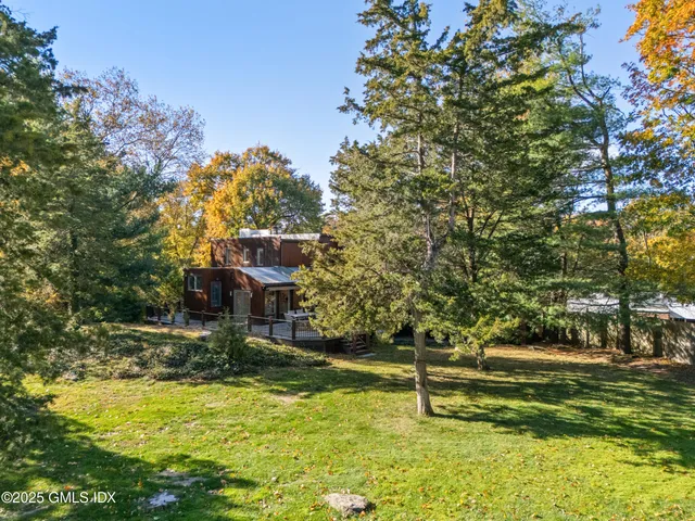 a swimming pool with outdoor seating and yard