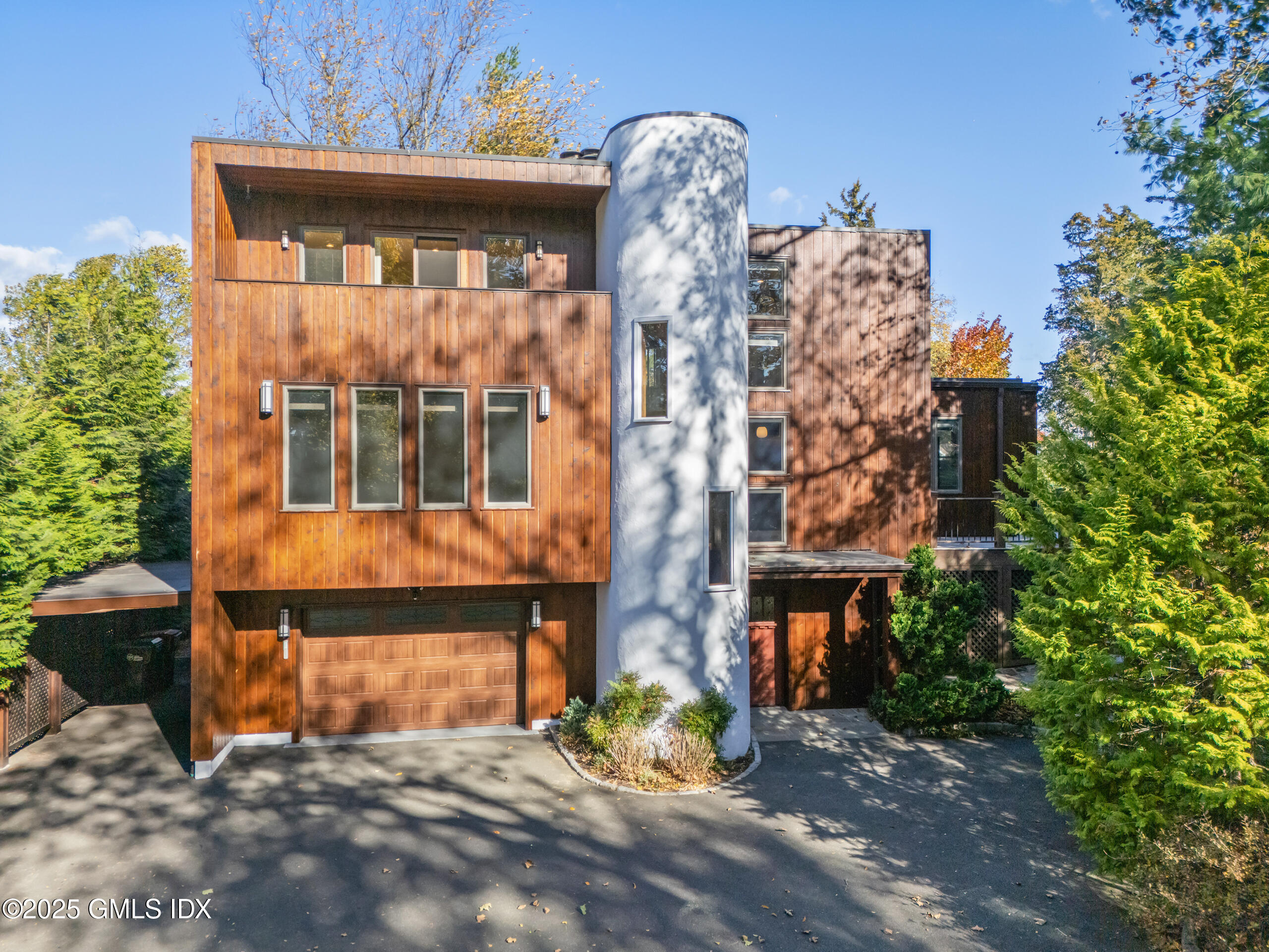 249 Shore Road Greenwich, CT 06830 - Photo 38 of 38 a front view of a house with large windows