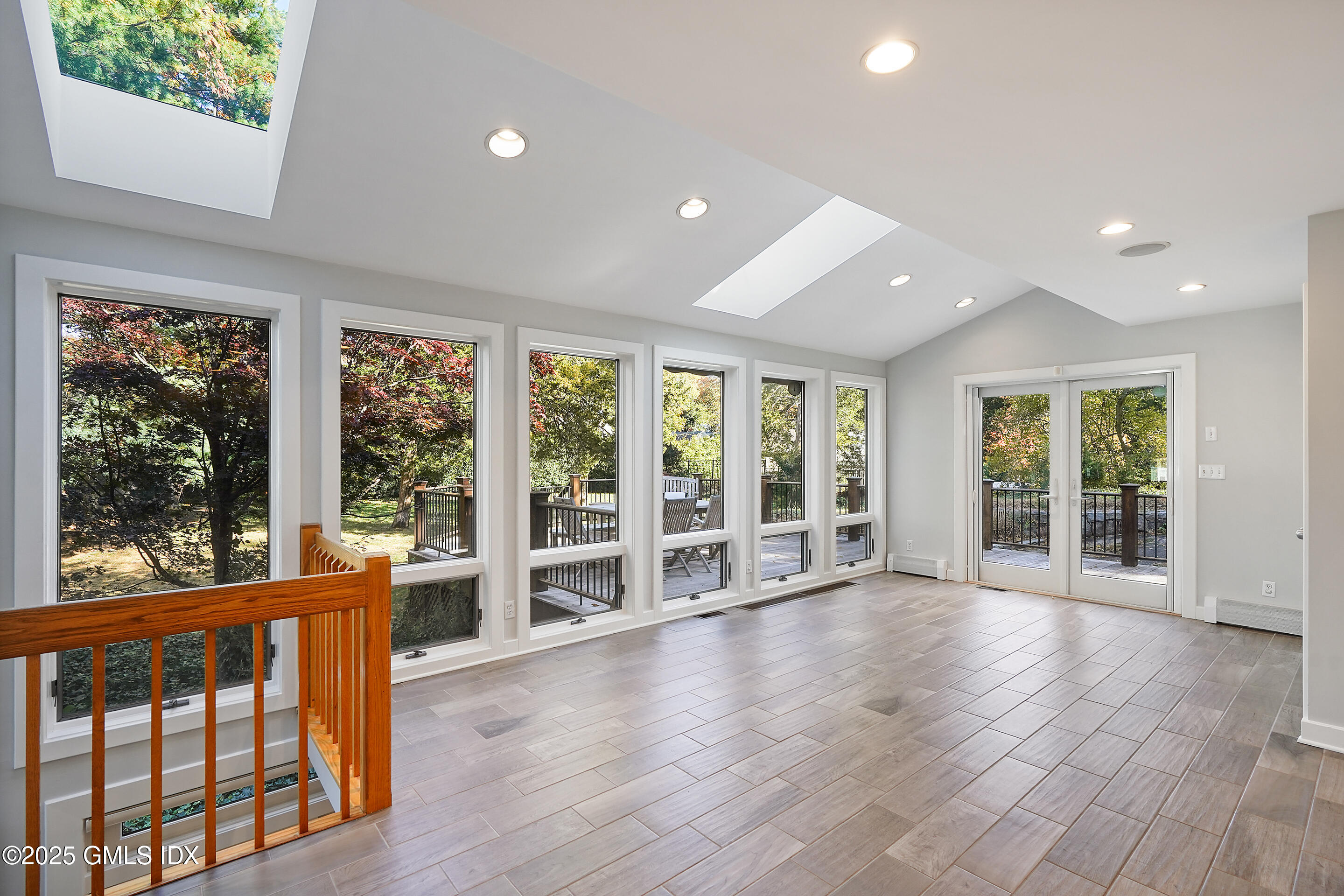 249 Shore Road Greenwich, CT 06830 - Photo 5 of 38 an empty room with wooden floor and large windows