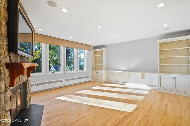 a spacious bedroom with a large window and a bed