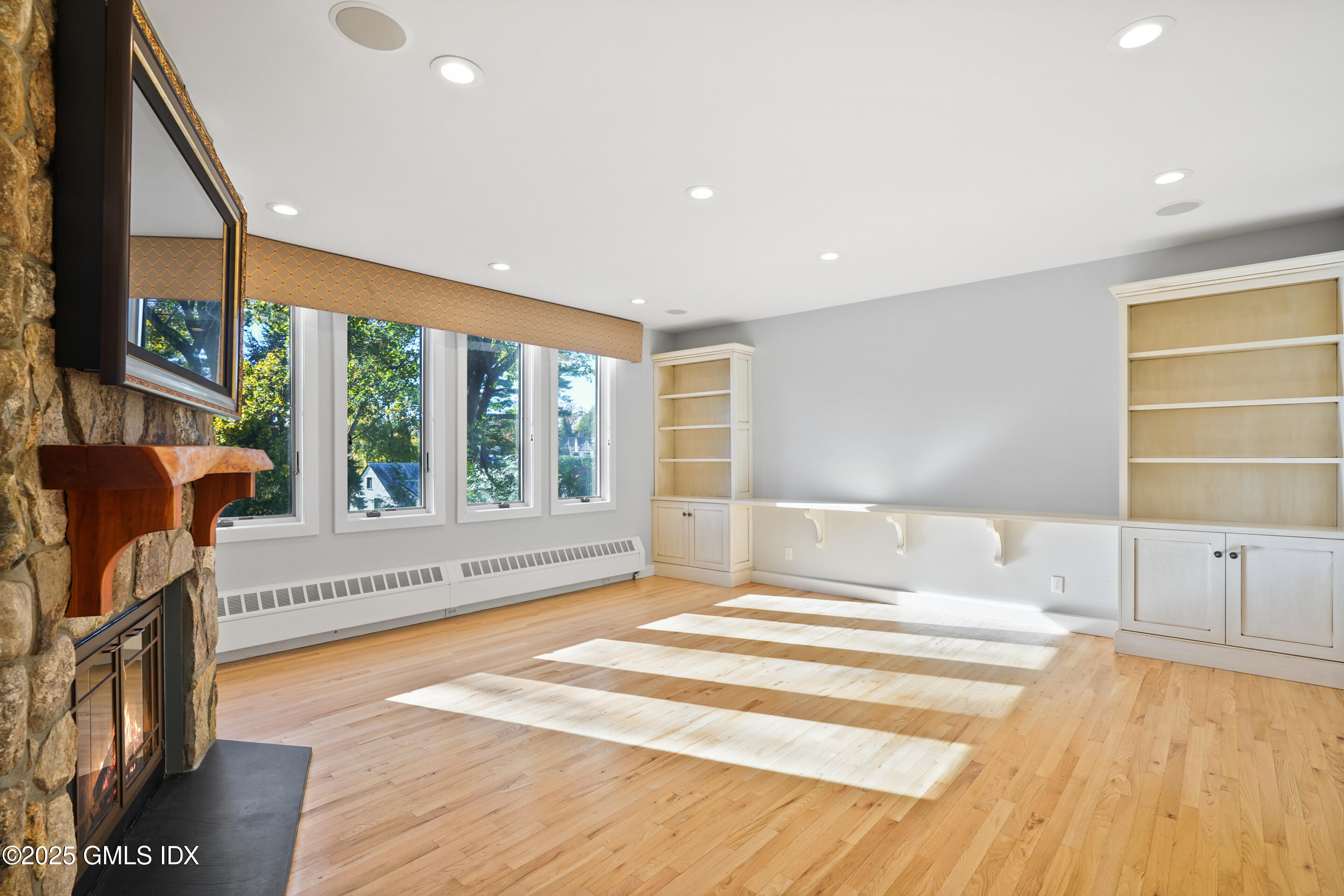 249 Shore Road Greenwich, CT 06830 - Photo 7 of 38 a spacious bedroom with a large window and a bed