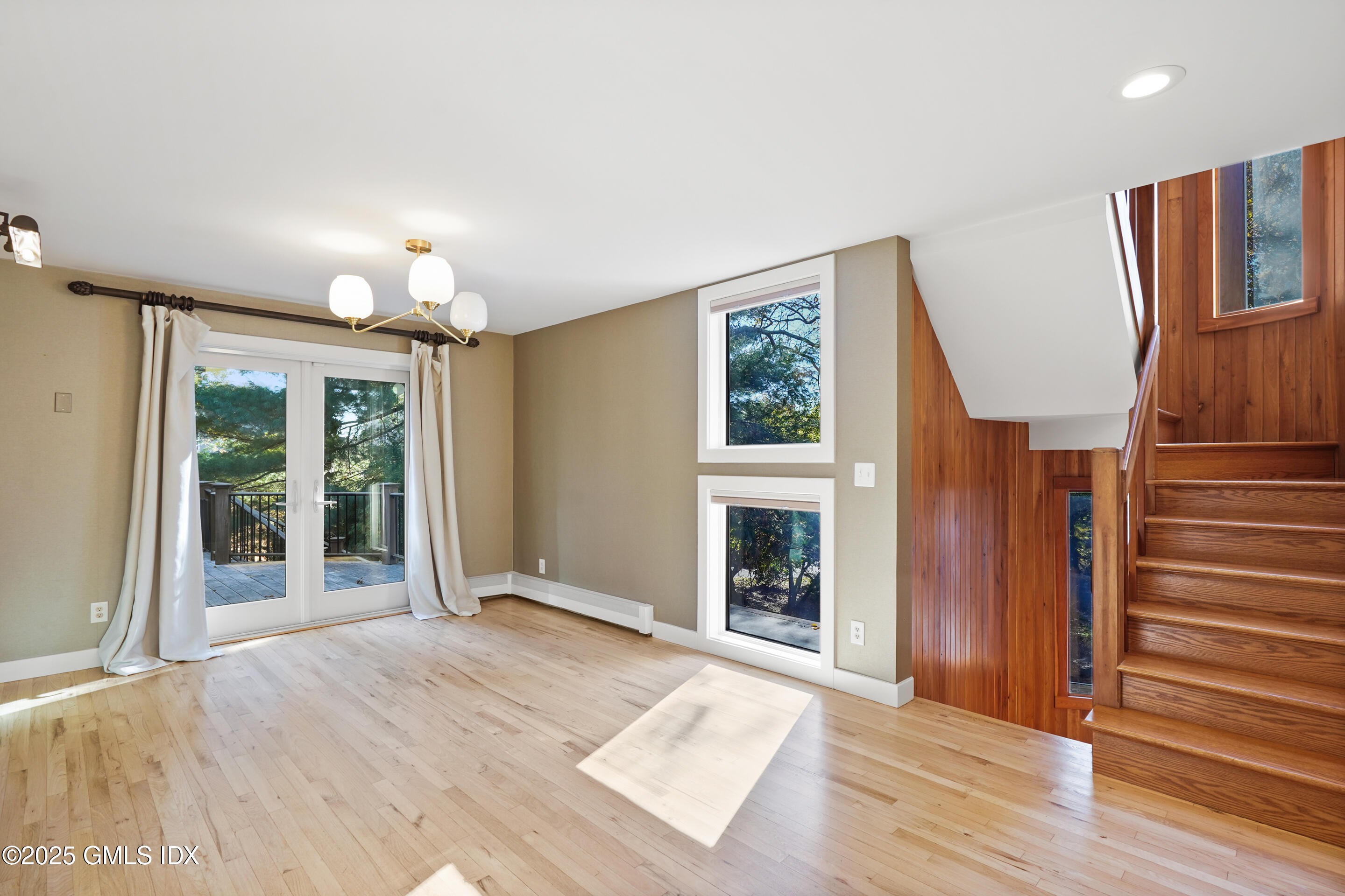 249 Shore Road Greenwich, CT 06830 - Photo 9 of 38 a view of an empty room with wooden floor fireplace and a window