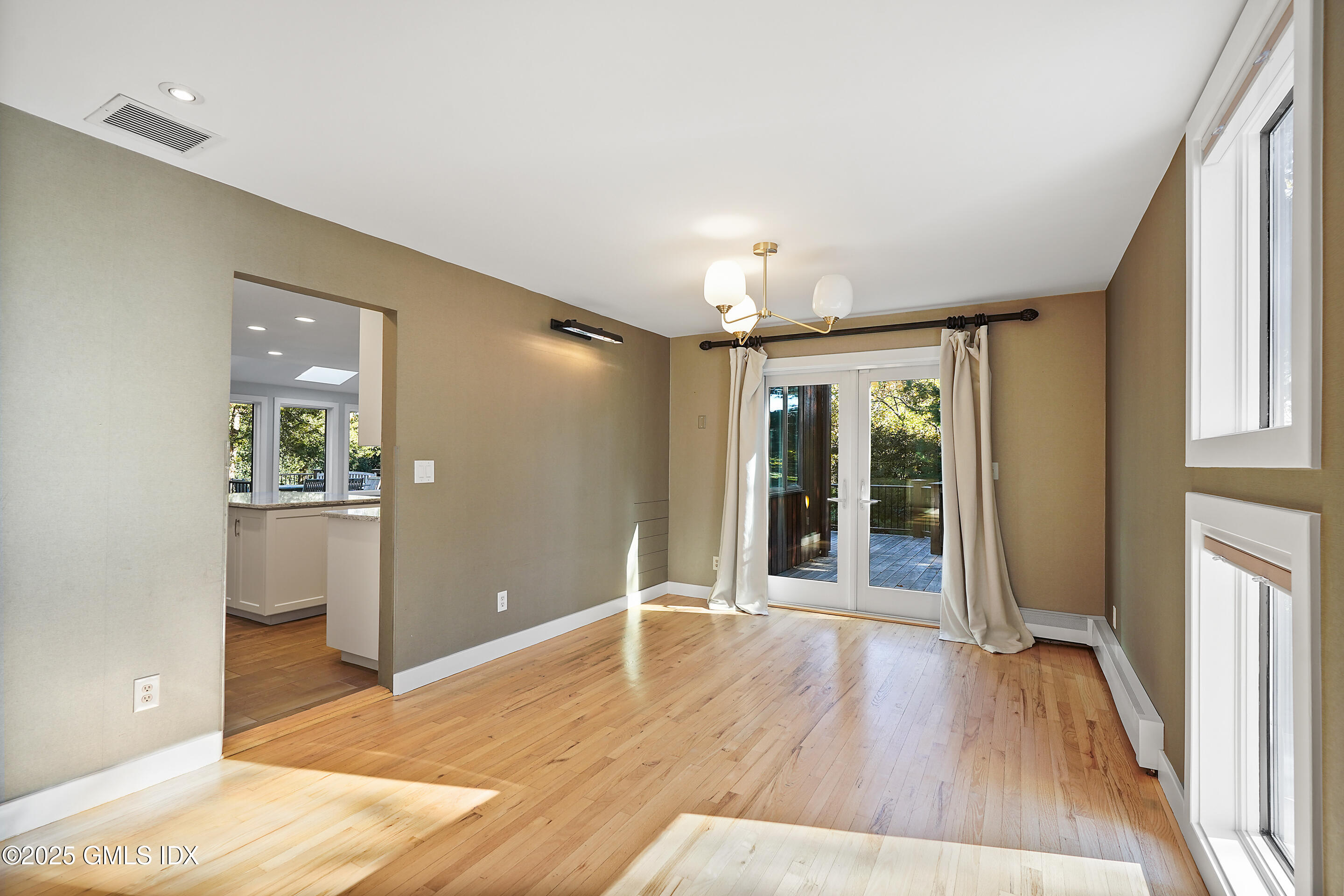 249 Shore Road Greenwich, CT 06830 - Photo 10 of 38 a view of an empty room with wooden floor and a window