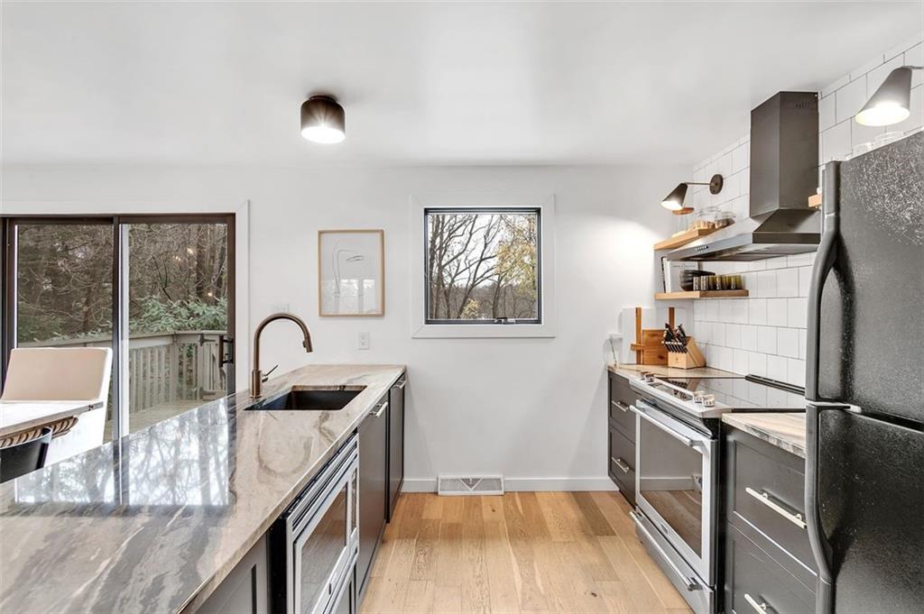 9763 Bellcrest Road Pittsburgh, PA 15237 - Photo 6 of 25 a kitchen with stainless steel appliances granite countertop a sink and a refrigerator