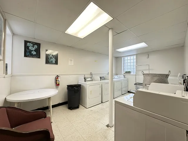 a view of a storage & utility room with two washing machine