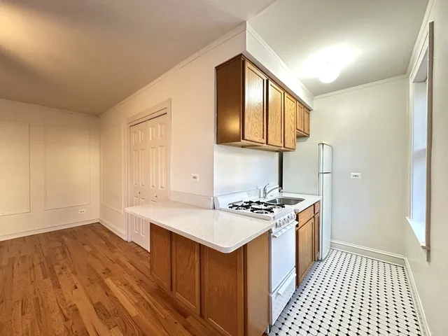 a kitchen with a stove a sink and a refrigerator