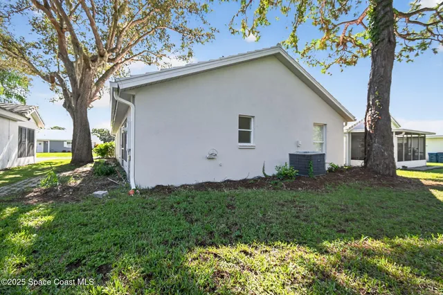 a house that has a tree in front of it