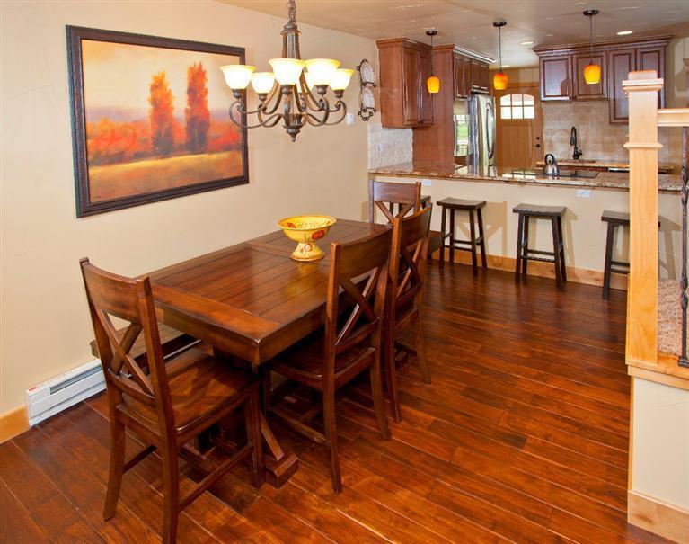 4192 Spruce Way, Unit 204A Vail, CO 81657 - Photo 4 of 21 a dining room with furniture a chandelier and wooden floor