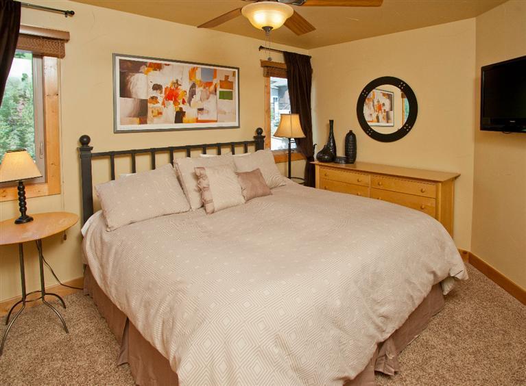 4192 Spruce Way, Unit 204A Vail, CO 81657 - Photo 5 of 21 a bedroom with bed and a chandelier