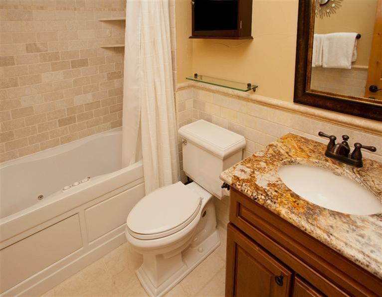 4192 Spruce Way, Unit 204A Vail, CO 81657 - Photo 6 of 21 a bathroom with a granite countertop toilet sink and mirror