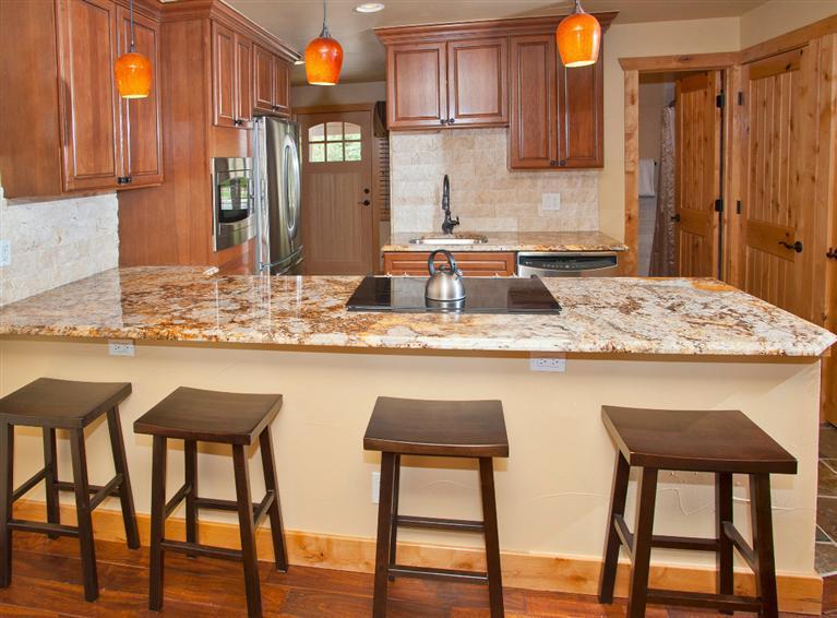 4192 Spruce Way, Unit 204A Vail, CO 81657 - Photo 8 of 21 a kitchen with a table chairs sink and cabinets