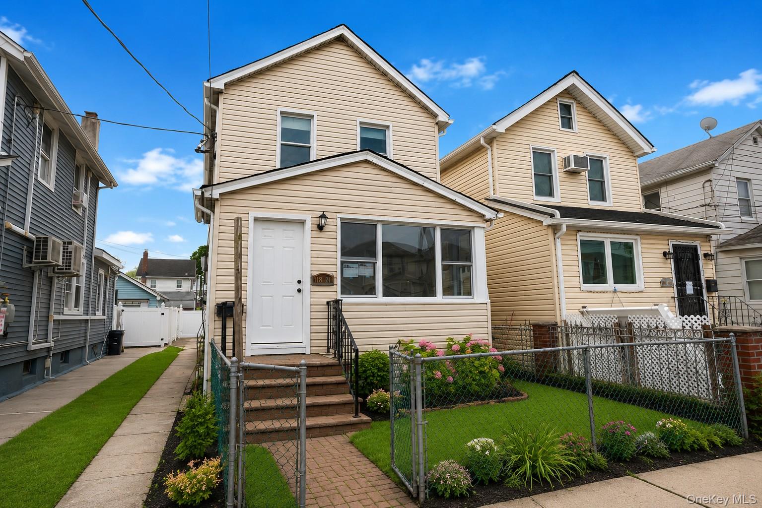 173-62 103rd Road Queens, NY 11433 - Photo 1 of 23 a front view of a house with a yard