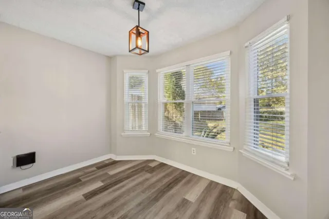 a kitchen with granite countertop white cabinets and stainless steel appliances