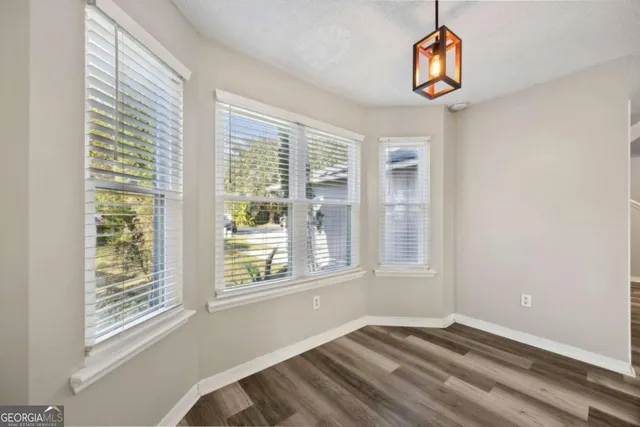 a kitchen with granite countertop white cabinets and white appliances