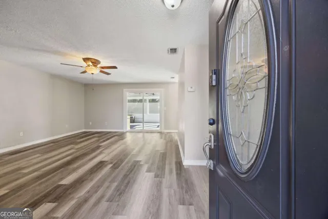 a view of a livingroom with wooden floor and a window