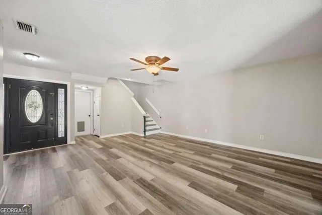 a view of a room with wooden floor and window
