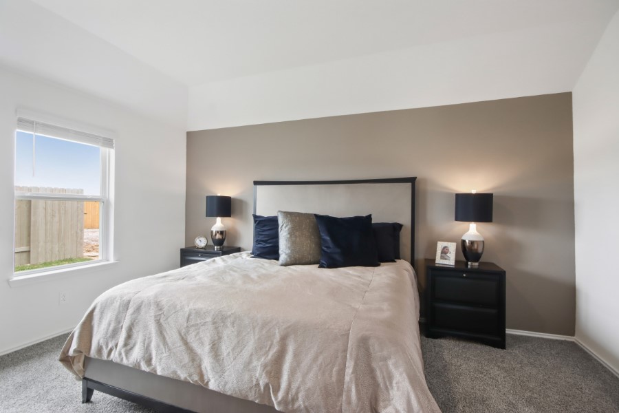 16903 Vinters Way Houston, TX 77090 - Photo 18 of 29 a bedroom with a bed and wooden floor