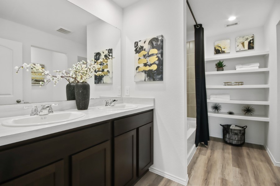 16903 Vinters Way Houston, TX 77090 - Photo 20 of 29 a en suite bathroom with a double vanity sink a mirror and a shower