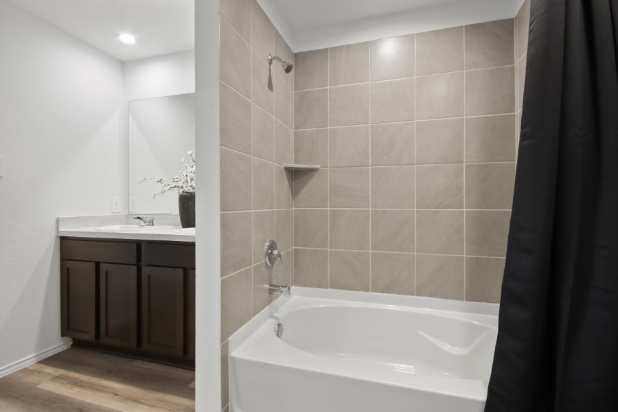 16903 Vinters Way Houston, TX 77090 - Photo 21 of 29 a bathroom with a bathtub and a sink
