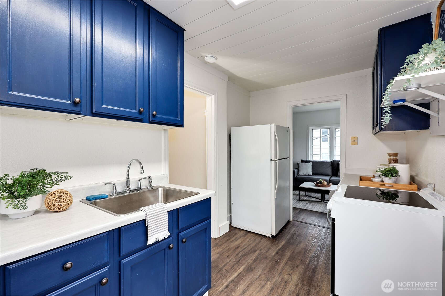 717 Franklin Street Port Townsend, WA 98368 - Photo 30 of 40 a kitchen with sink refrigerator and cabinets