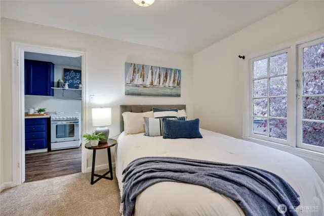 a bedroom with a bed and a potted plant