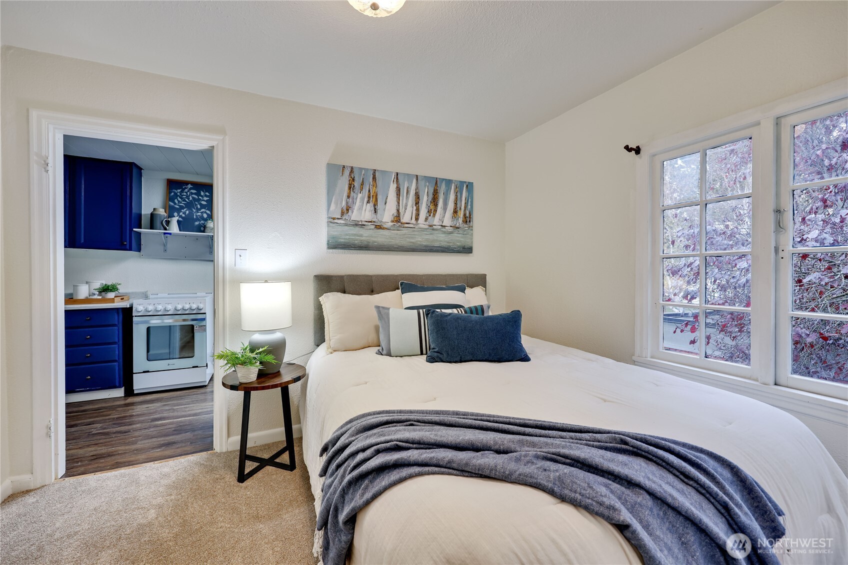 717 Franklin Street Port Townsend, WA 98368 - Photo 33 of 40 a bedroom with a bed and a potted plant