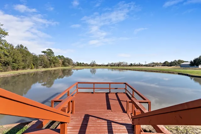 a view of a house with pool yard and a patio