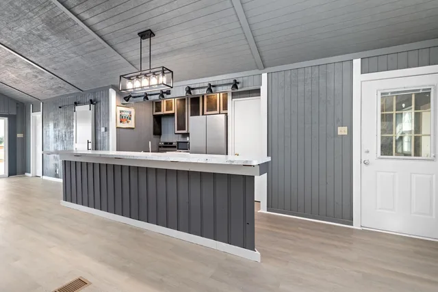 a kitchen with stainless steel appliances granite countertop a sink dishwasher a refrigerator and a stove