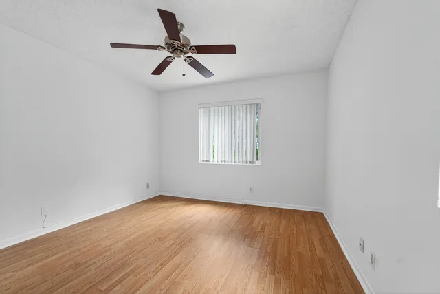 a view of a room with wooden floor and white walls