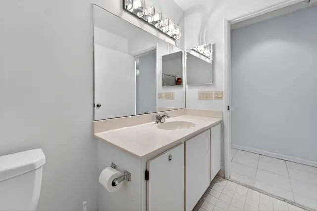 a bathroom with a sink a mirror and a toilet