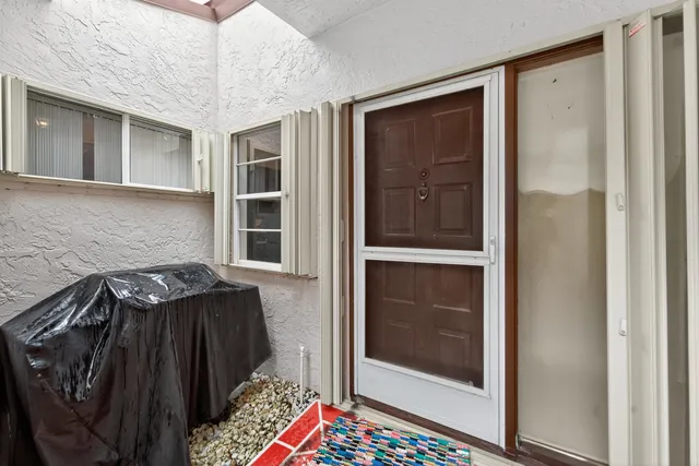 a front view of a house with a garden and yard