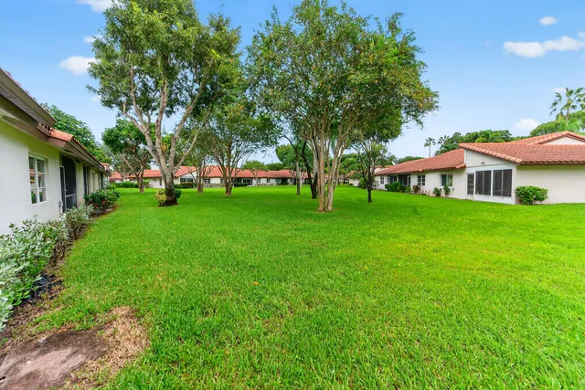 a front view of a house with a garden and yard