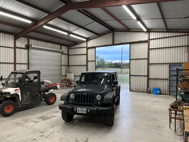 a garage with a couch and a chandelier
