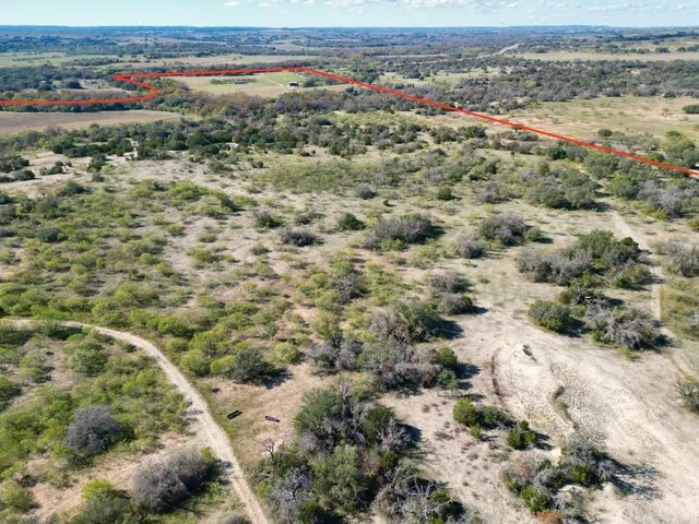 a view of a field with an ocean view