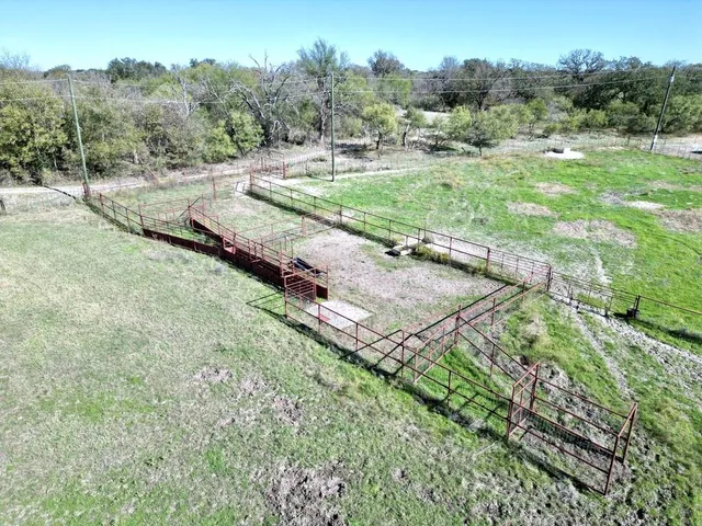 an aerial view of a house with a yard and trees