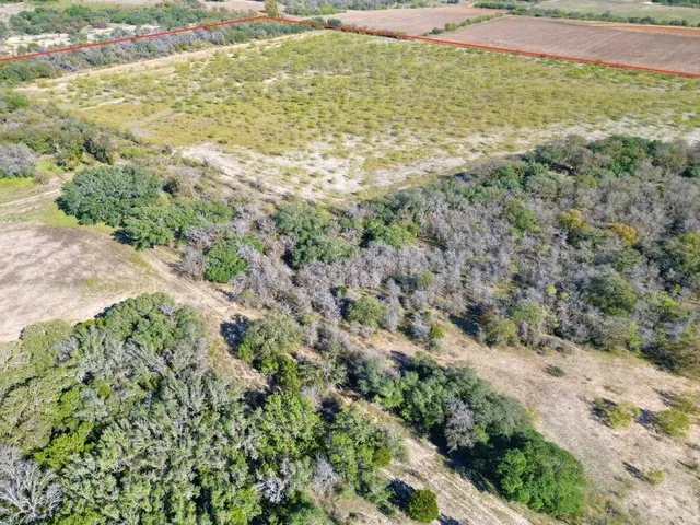 a view of a field with an ocean view