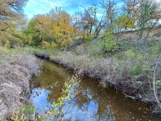 a view of a lake with a yard