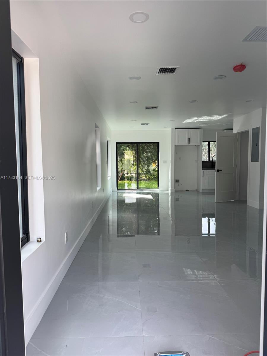 2970 Northwest 45th Street Miami, FL 33142 - Photo 2 of 26 a view of a hallway view with wooden floor and a living room