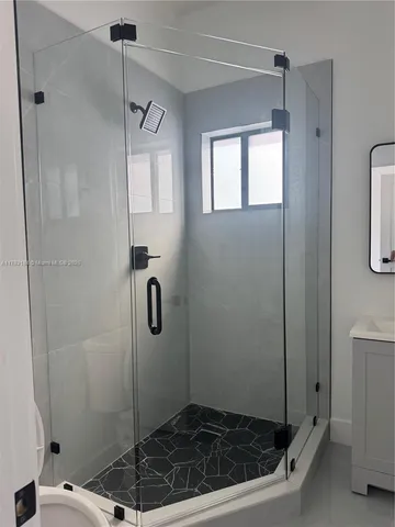 a bathroom with a sink a toilet and mirror