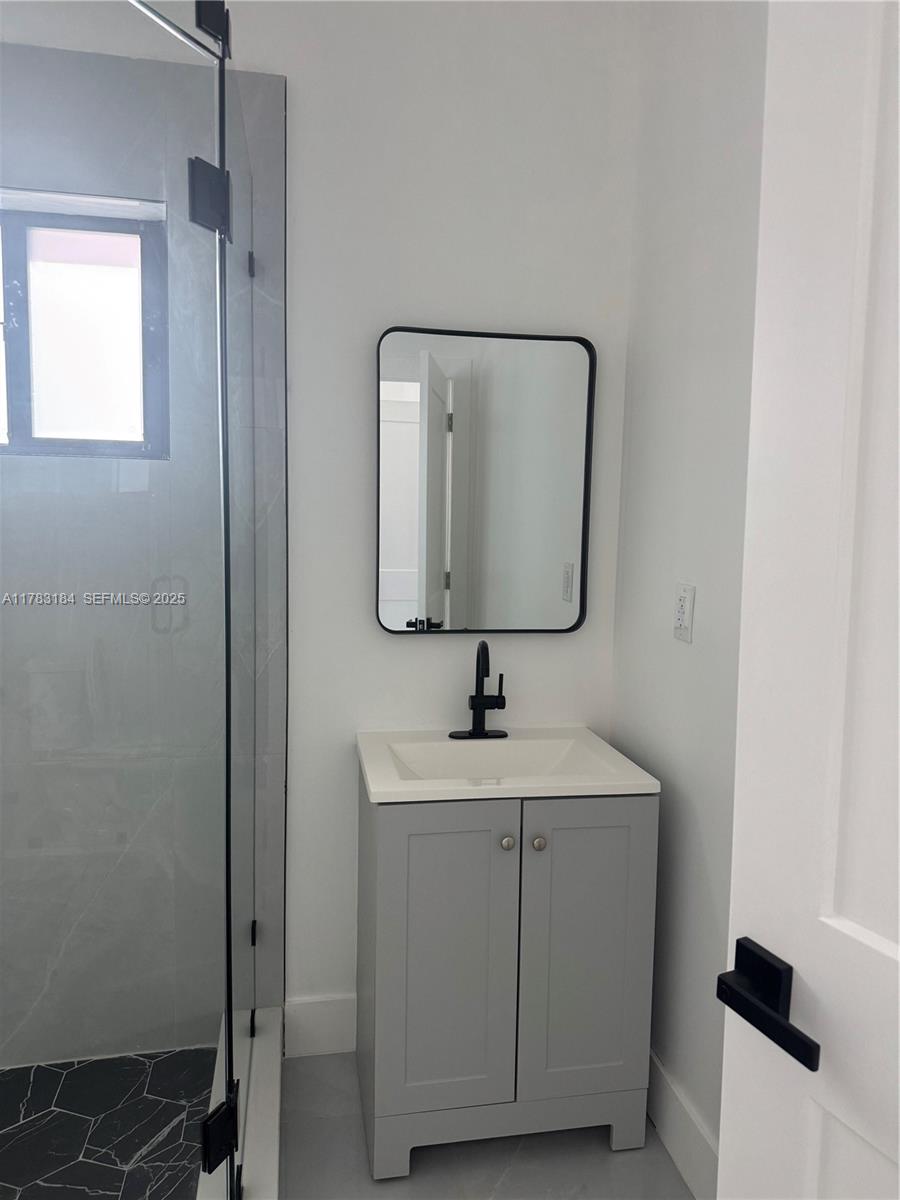 2970 Northwest 45th Street Miami, FL 33142 - Photo 22 of 26 a bathroom with a sink and a mirror