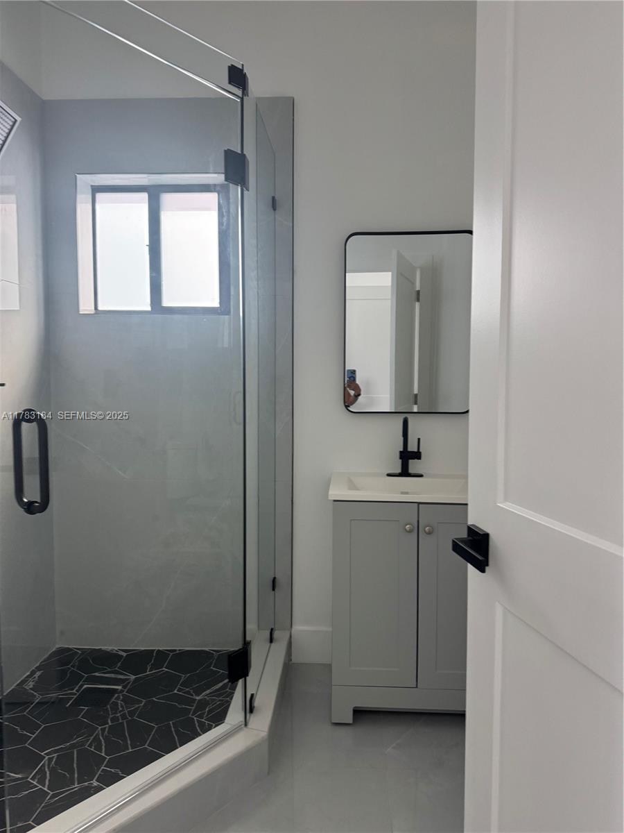 2970 Northwest 45th Street Miami, FL 33142 - Photo 23 of 26 a bathroom with a sink a toilet and mirror