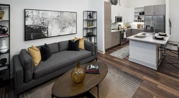 a living room with furniture and a painting on the wall