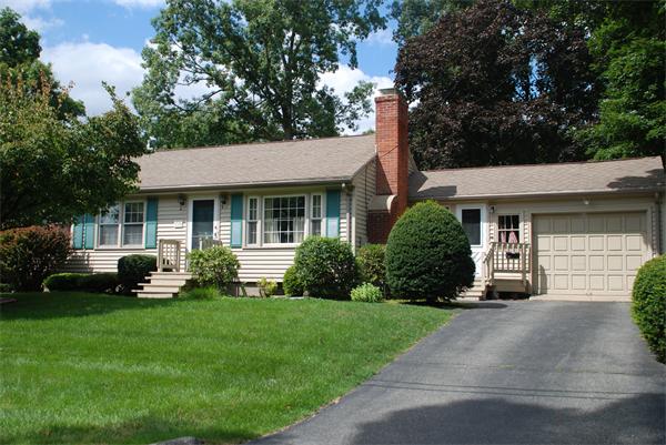 38 Endecott Street Springfield, MA 01118 - Photo 1 of 17 a front view of a house with a yard and garage
