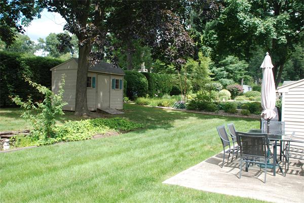 38 Endecott Street Springfield, MA 01118 - Photo 15 of 17 a view of a chair and table in backyard of the house