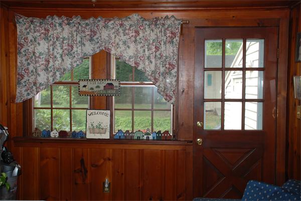 38 Endecott Street Springfield, MA 01118 - Photo 3 of 17 a view of a porch with a floor to ceiling window and a tree