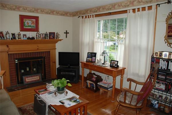 38 Endecott Street Springfield, MA 01118 - Photo 6 of 17 a living room with furniture and a fireplace