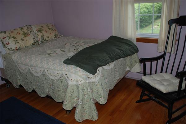 38 Endecott Street Springfield, MA 01118 - Photo 7 of 17 a bed sitting in a bedroom next to a window