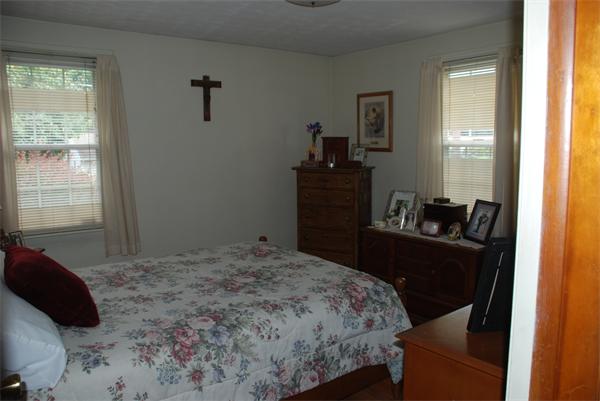 38 Endecott Street Springfield, MA 01118 - Photo 8 of 17 a bedroom with a bed and wooden floor