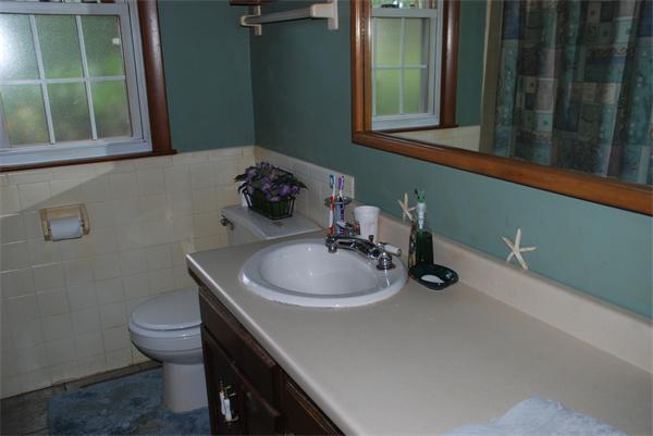 38 Endecott Street Springfield, MA 01118 - Photo 9 of 17 a bathroom with a sink a toilet and a mirror
