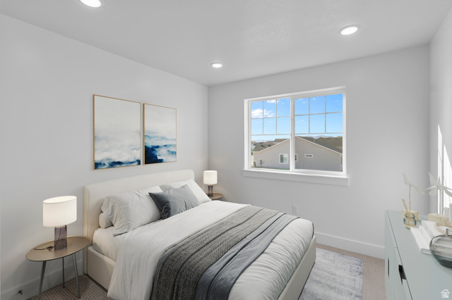 257 West 2950th Street South Logan, UT 84321 - Photo 9 of 11 Bright bedroom featuring large multi-pane windows with natural light, recessed ceiling lighting, neutral wall finishes, and wood-finish flooring